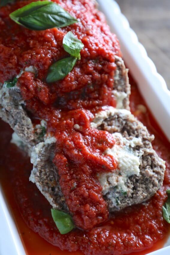 Keto Lasagna Meatloaf cut into slices and garnished with marinara and fresh basil