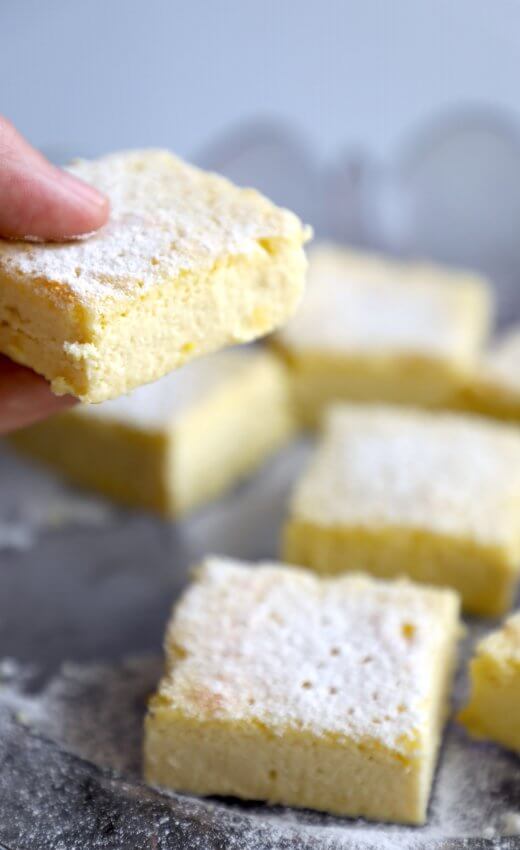 hand holding a slice of Keto Lemon Magic Custard Cake
