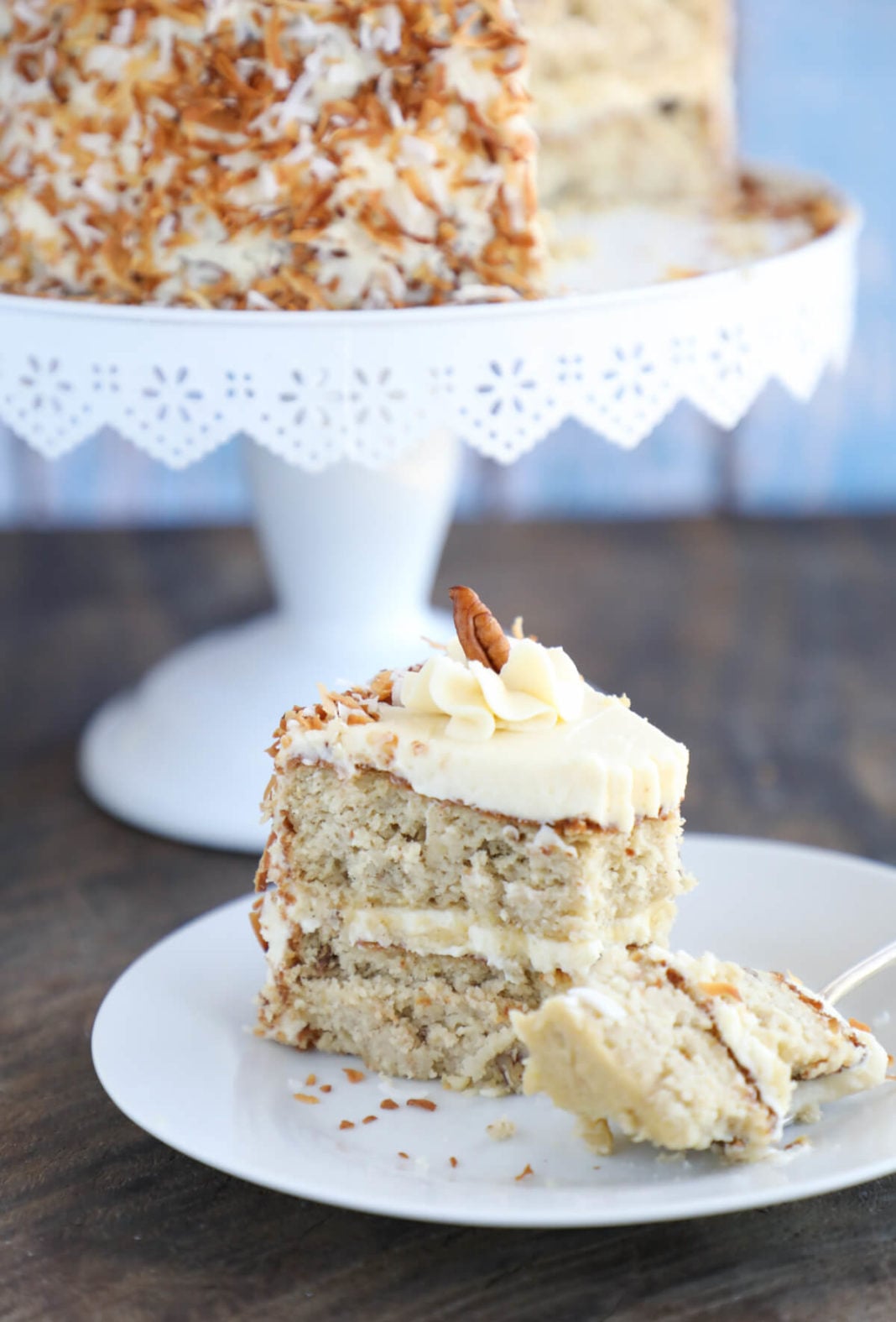 Slice of Keto Hummingbird Cake with a forkful on the white plate front view