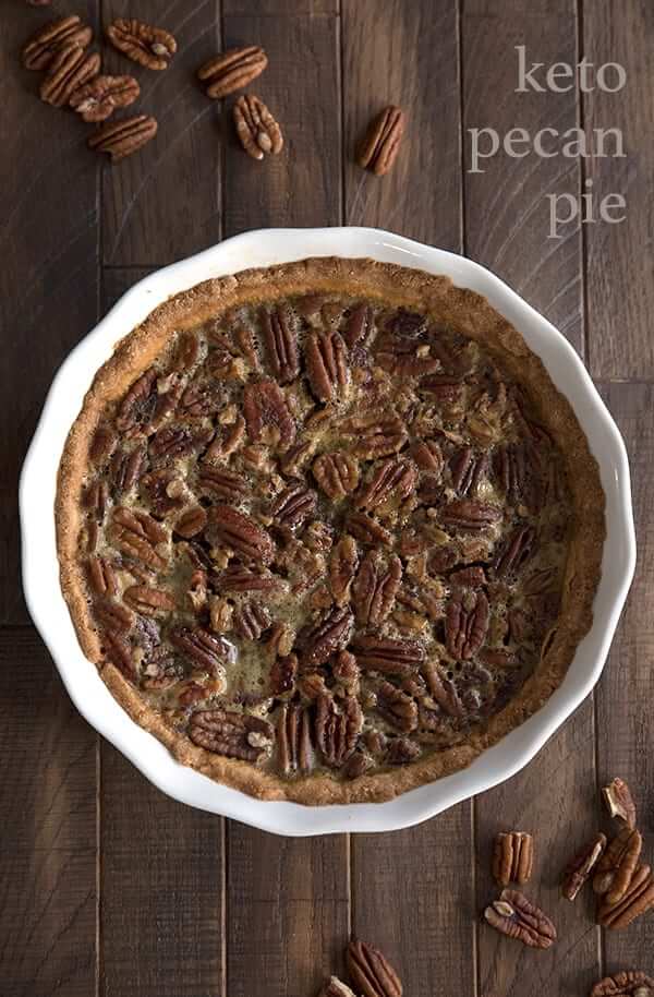 low carb pecan pie on wooden background in a white pie plate
