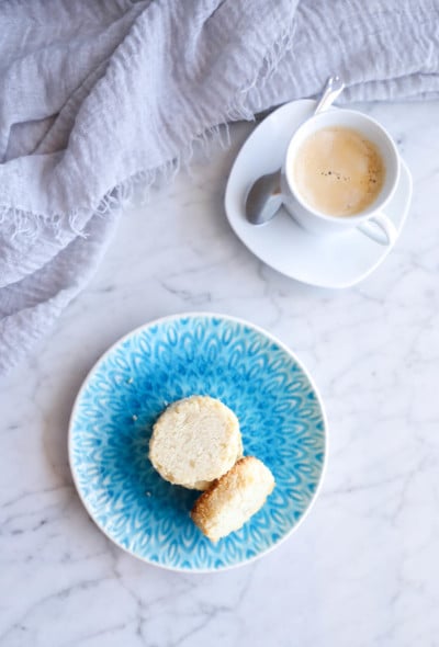 keto coconut shortbread cookies on a blue plate with a white espresso in the background