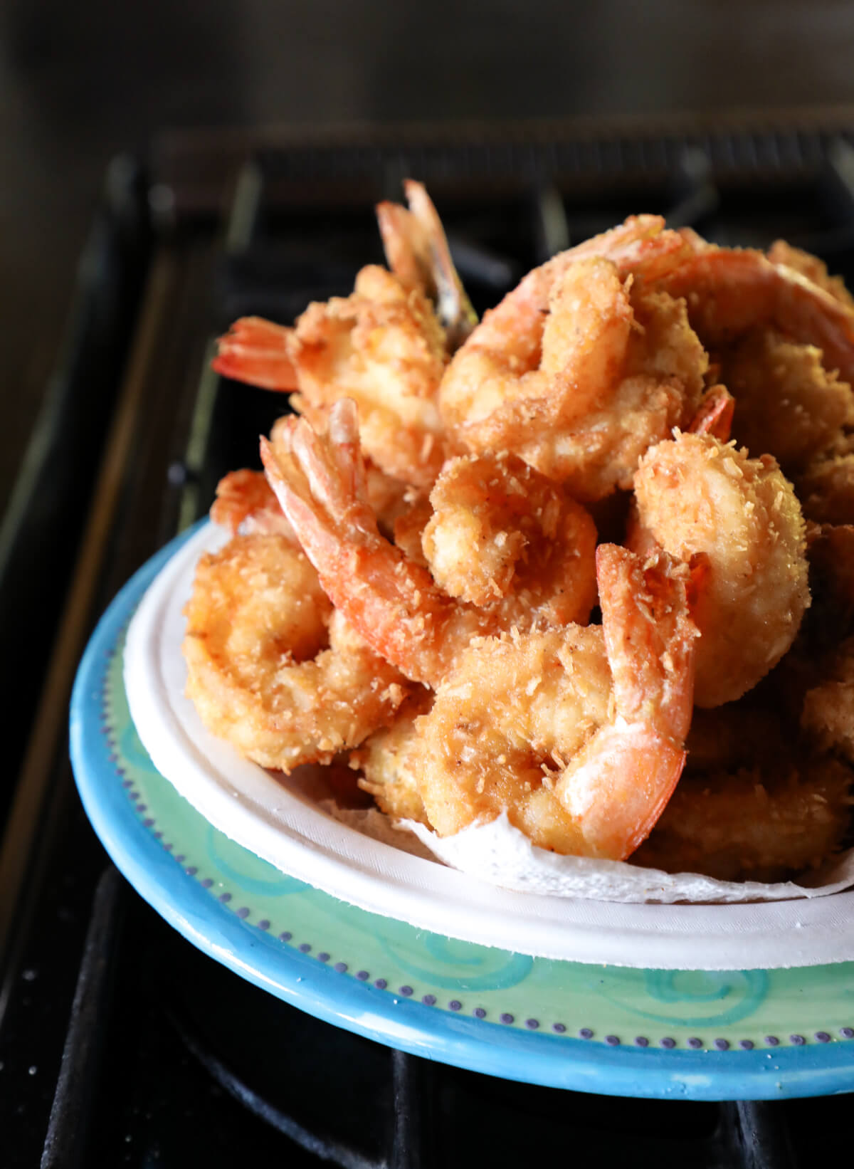 Shrimp fresh out of the fryer on a paper plate