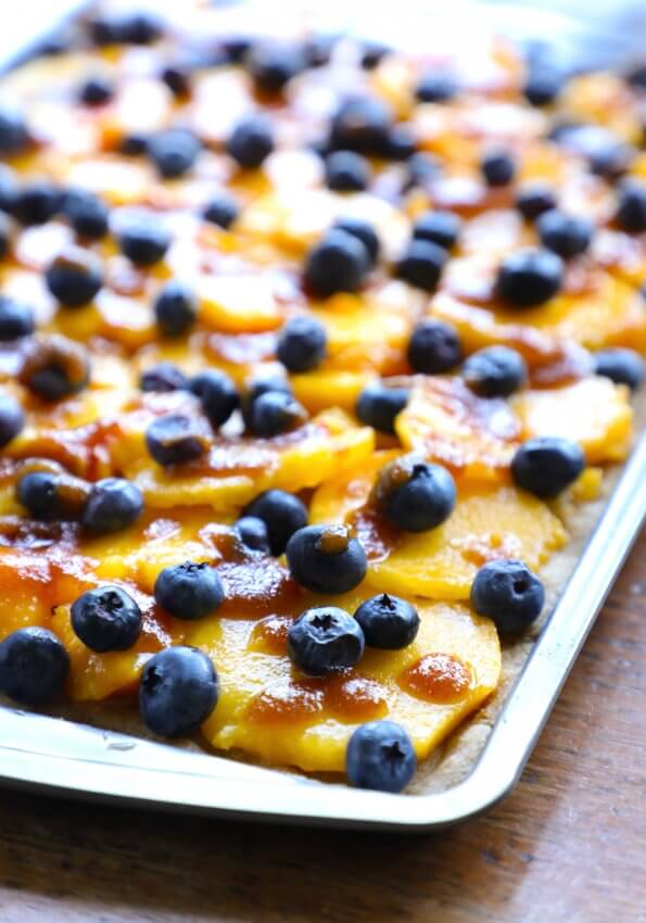 keto peach and blueberry slab pie on a cookie sheet before baking