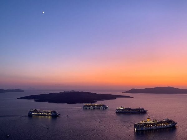 IBIH Vacation Travel Guide to Santorini - Sunset with cruise ships over the Caldera
