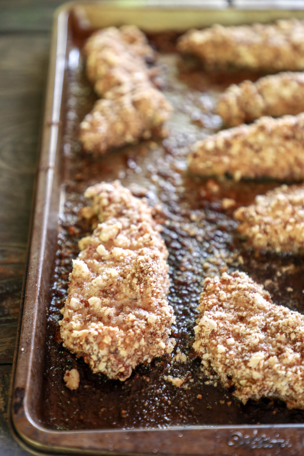 Keto Peanut Chicken Tenders on a cookie sheet after baking for 20 minutes