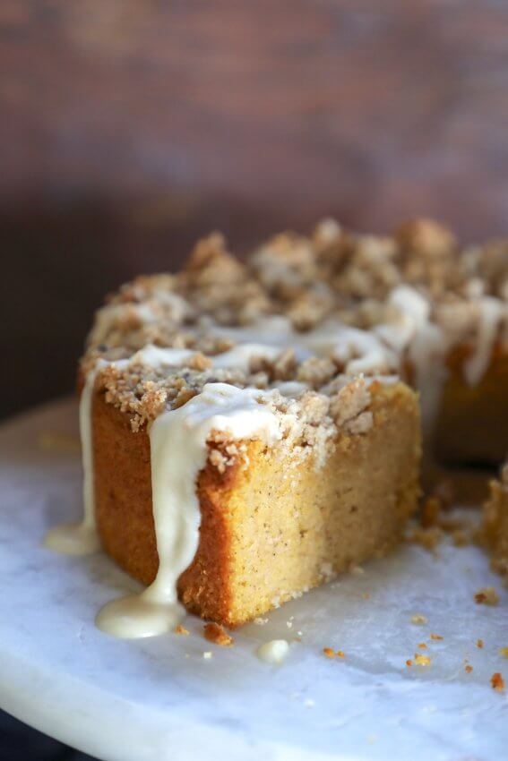 keto pumpkin chai coffee cake cross section with a drip of chai glaze
