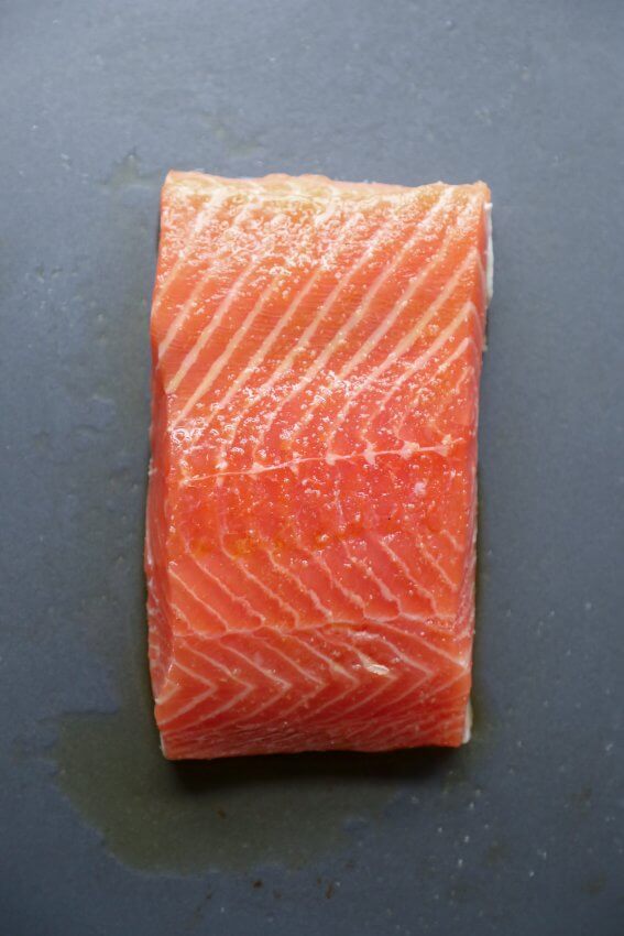 Filet of salmon on a sheet pan ready to be roasted