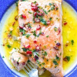 Keto Salmon with Cranberry Orange Butter on a blue and white plate