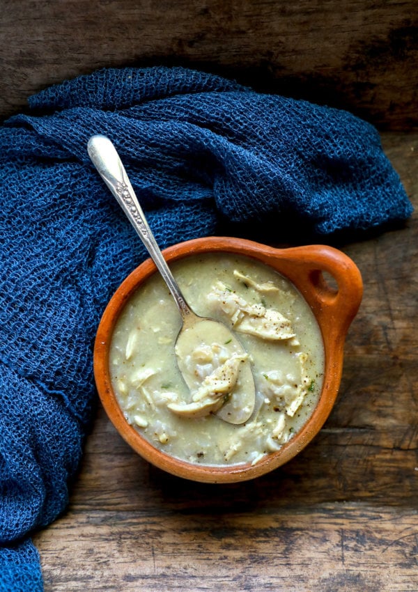 Keto Chicken & Rice Soup in a clay bowl on a rustic wooden background