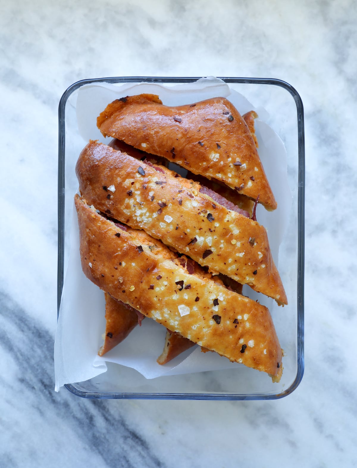 Keto Stromboli sliced and in a glass container for meal prepping