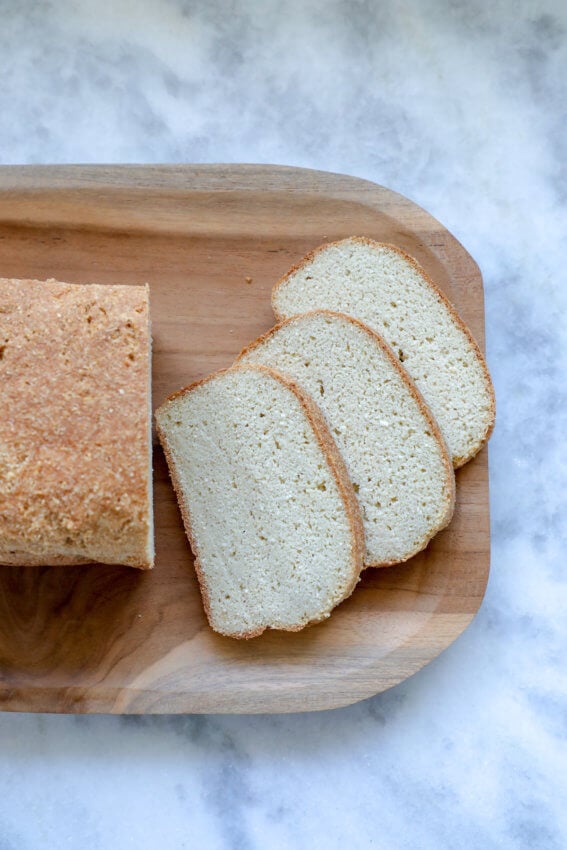 Top view of easy Keto Bread recipe with 3 slices on a wooden board