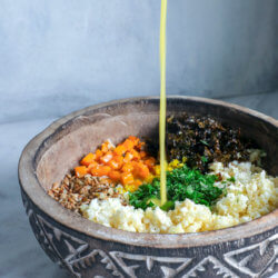 pouring the dressing over Keto Roasted Cauliflower Couscous