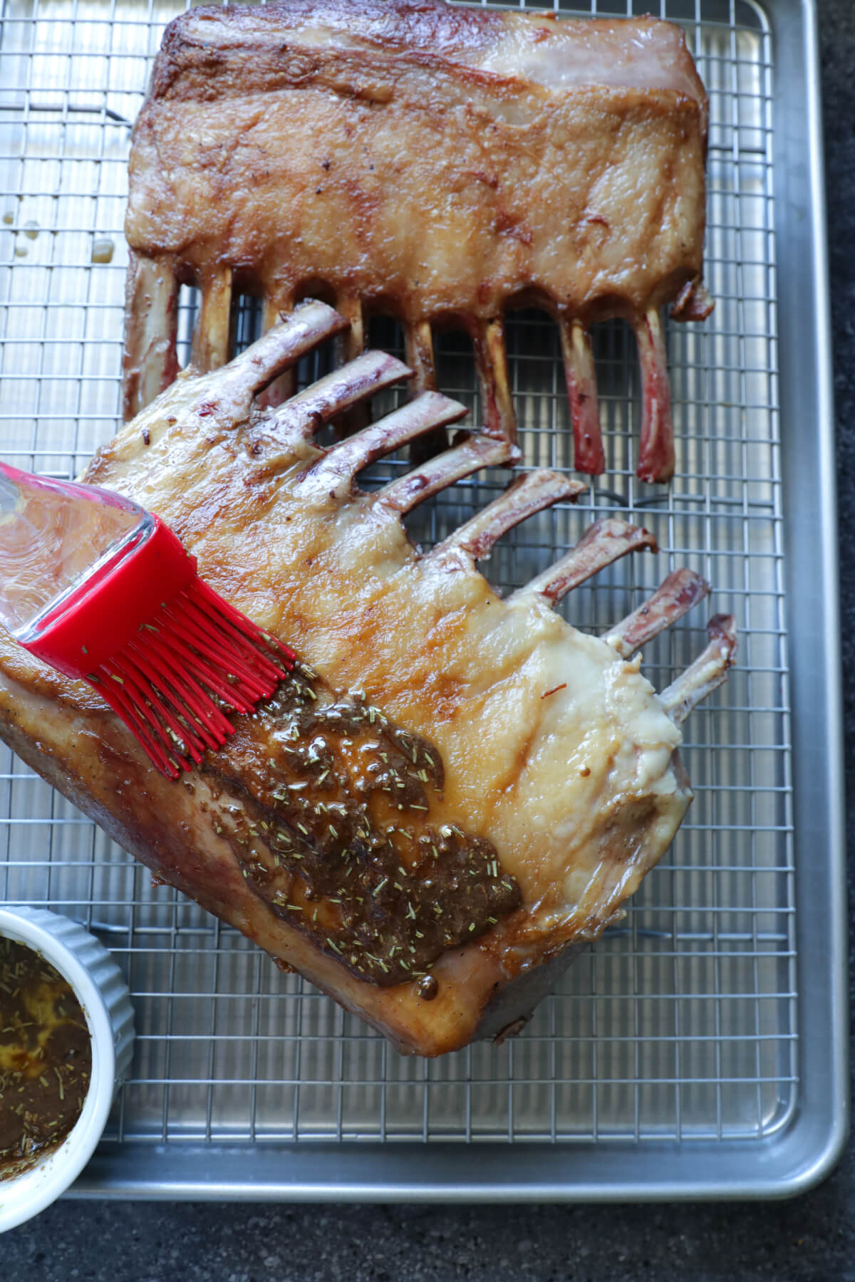Keto Rack of Lamb being basted with spice rub