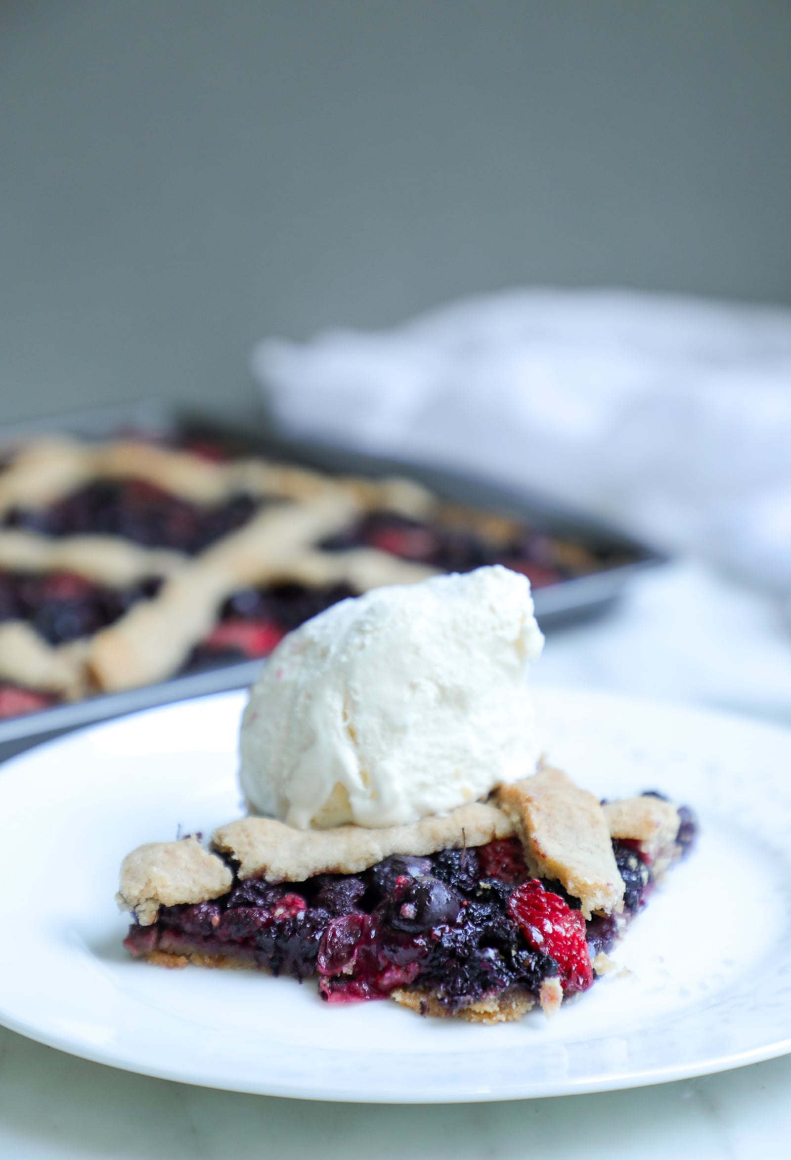 Keto Mixed Berry Slab Pie with low carb vanilla ice cream on top