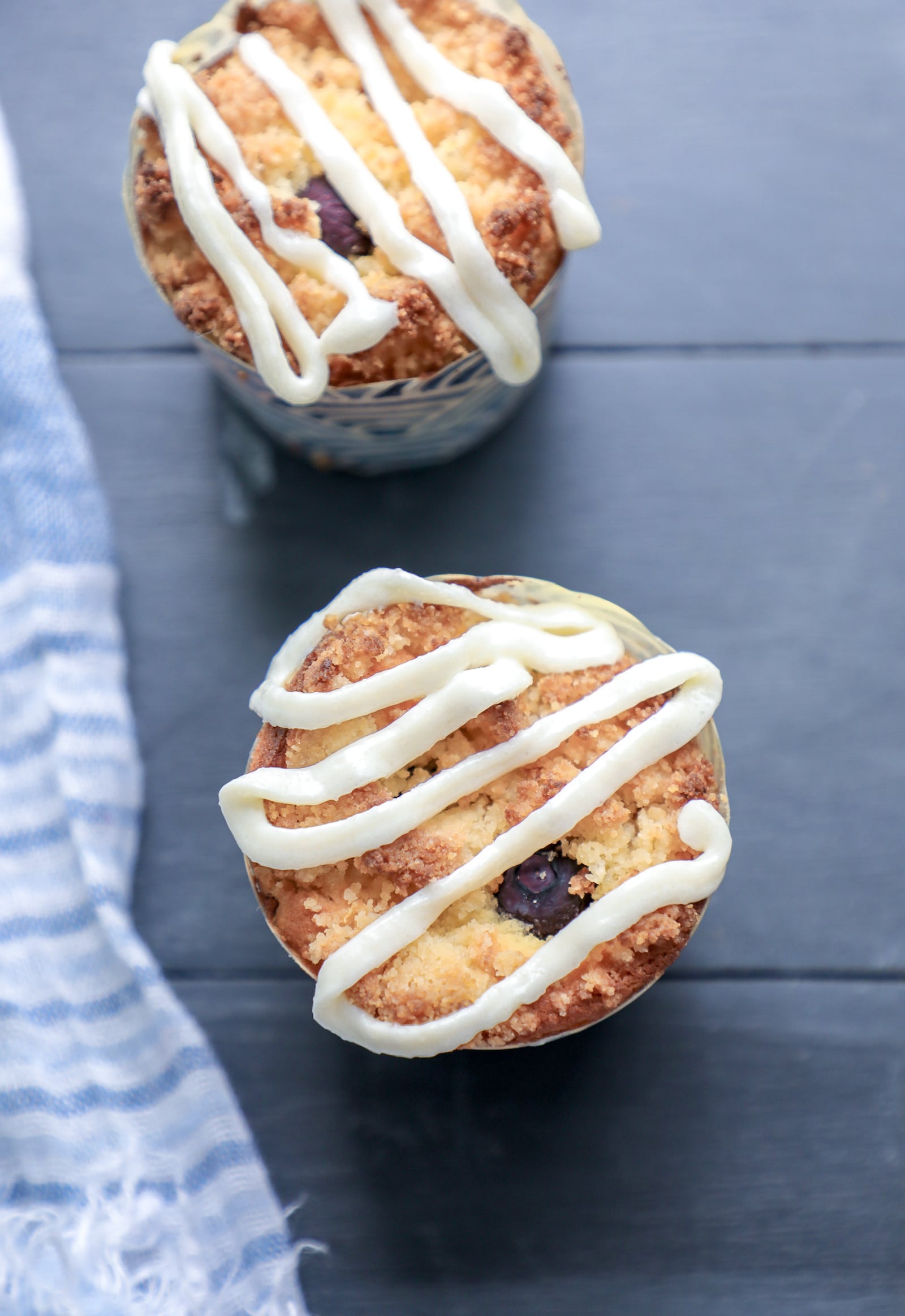 Top view of keto blueberry muffins with lemon icing