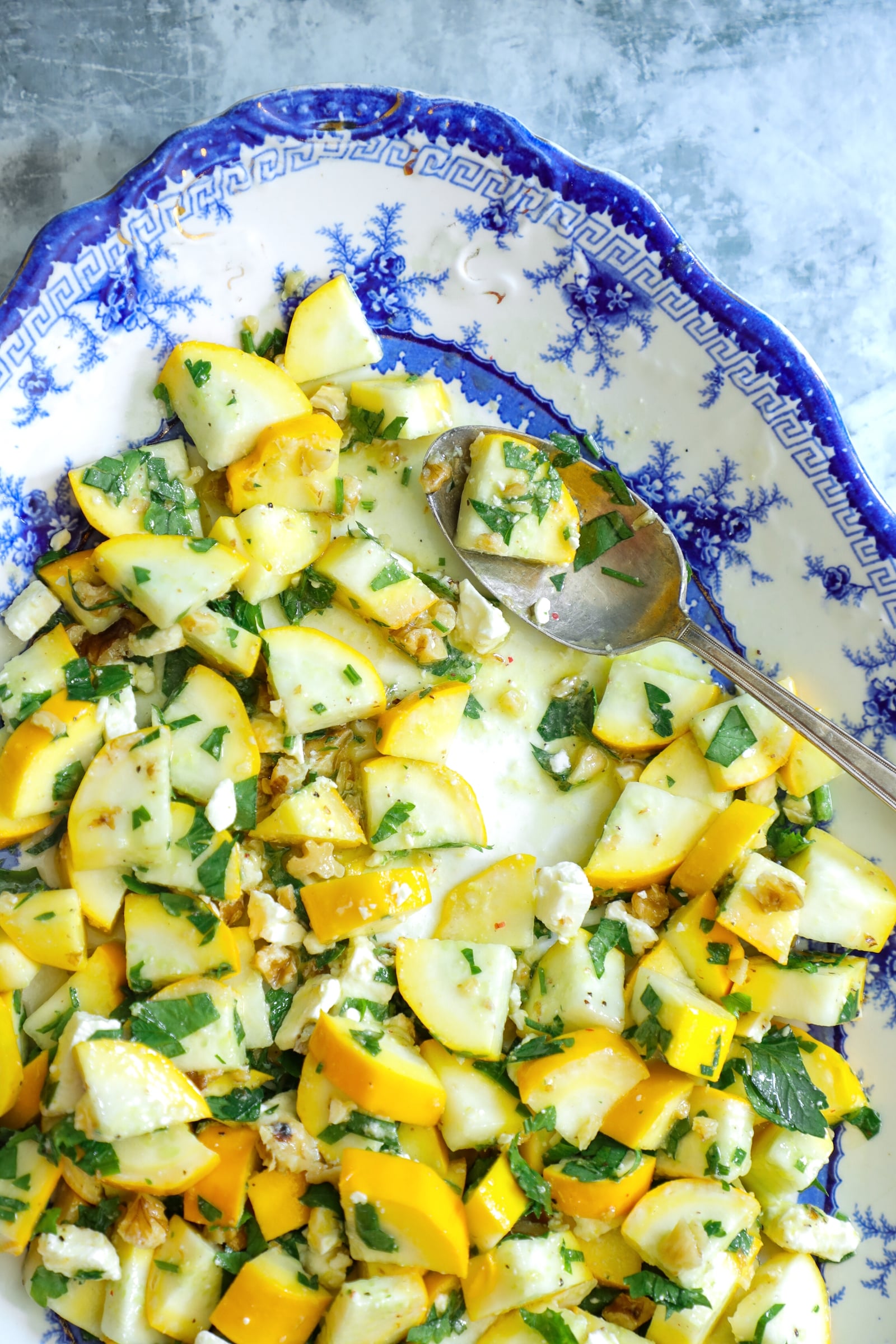keto summer squash salad on a blue and white platter