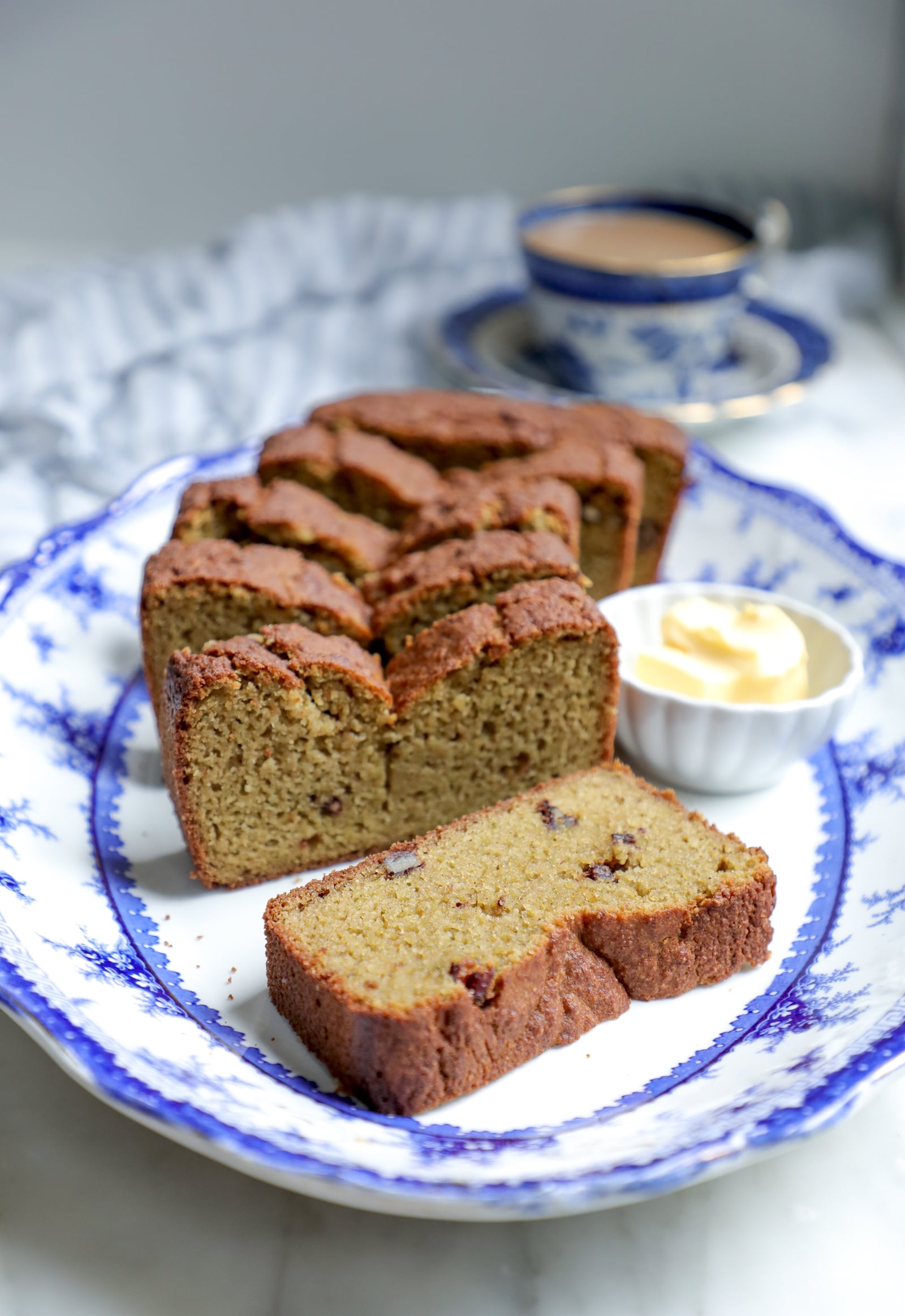 Front view of low carb zucchini bread sliced to show the nuts and moist interior.