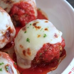 Keto Meatballs with marinara sauce, melted mozzarella cheese, and a sprinkle of parsley