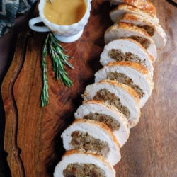 slices of turkey roulade arranged on a wooden serving board