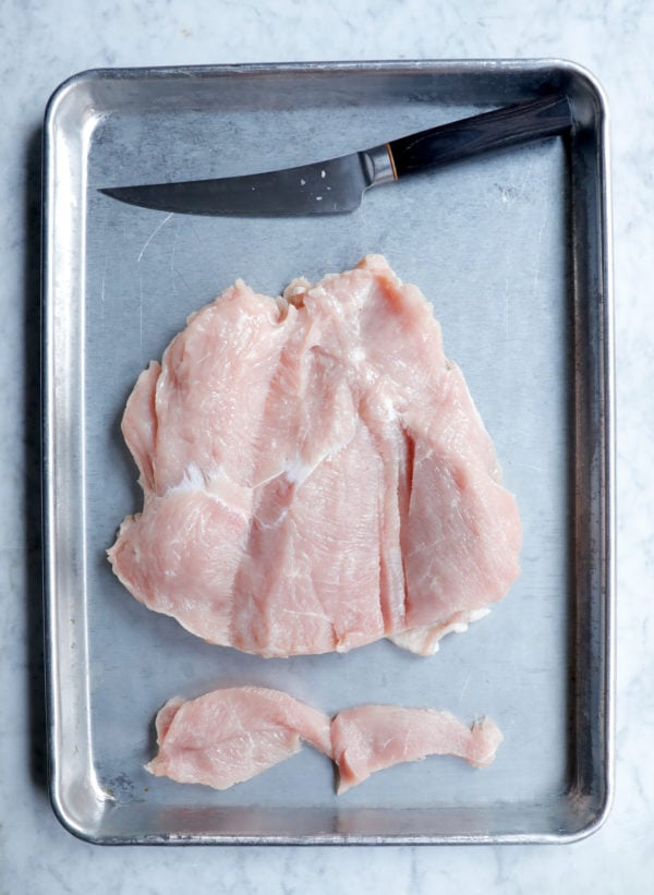 Trimmed turkey breast folded out and ready to stuff