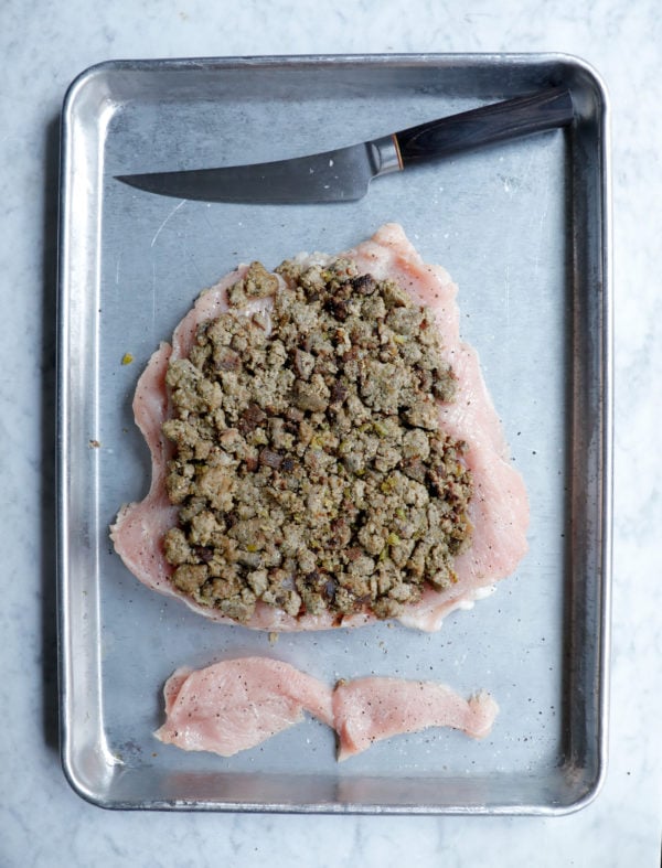 turkey roulade before rolling, with the stuffing over the meat to the edges