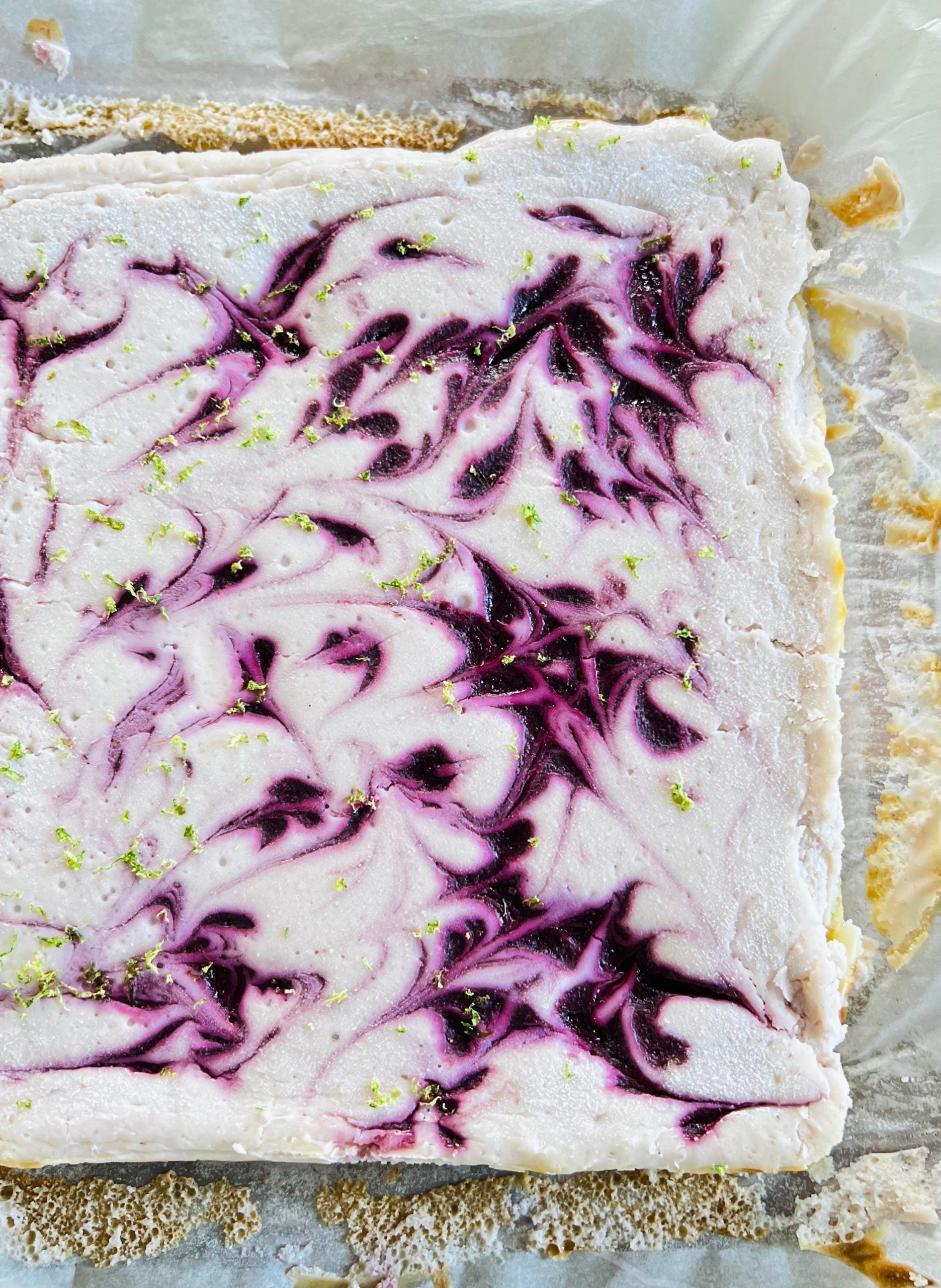 blackberry lime cheesecake square on parchment paper