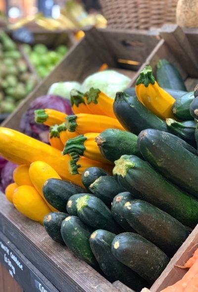 Green and Yellow zucchini stacked in boxes at a market