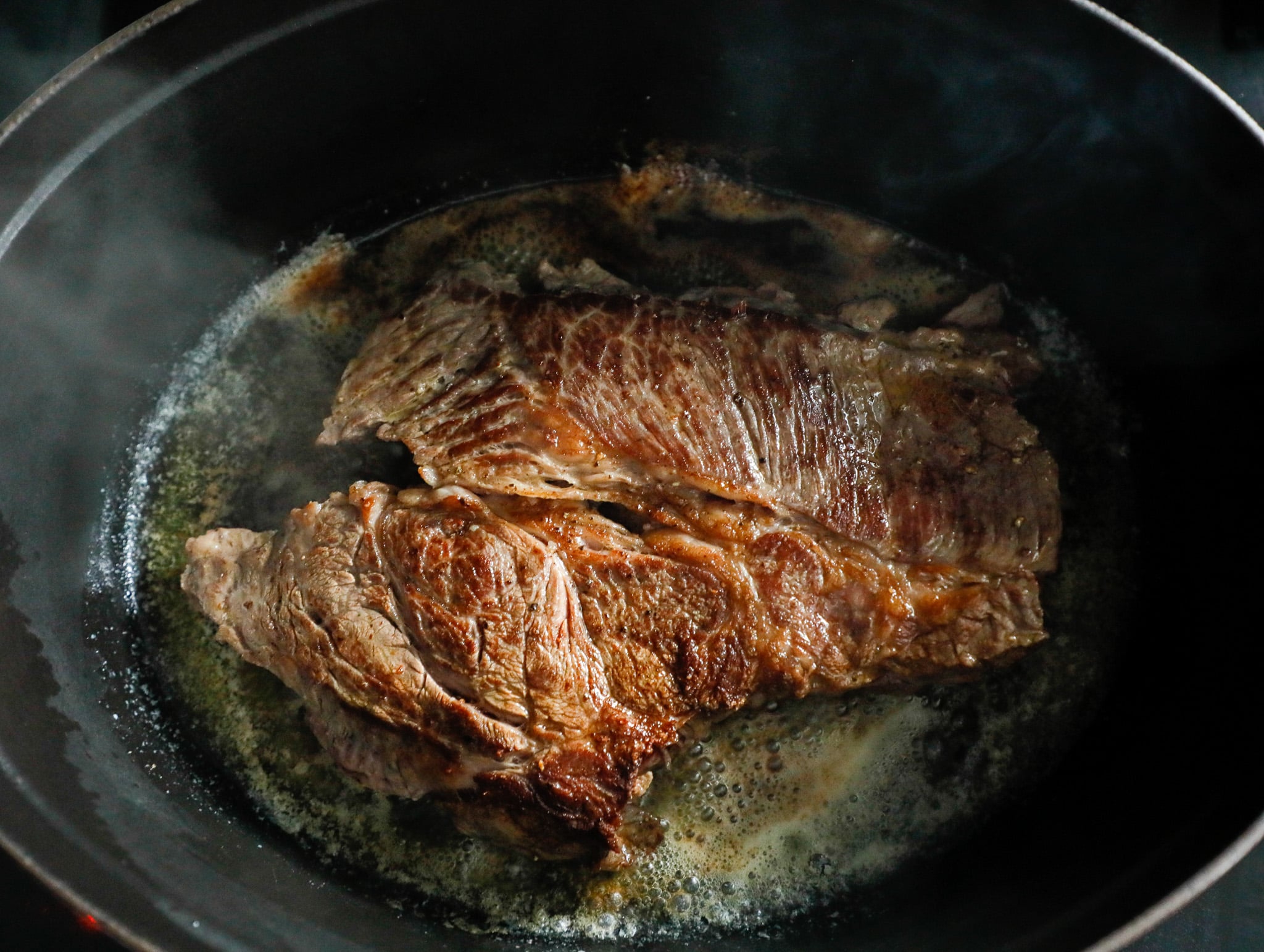 Seared Chuck Roast shown in a Dutch Oven