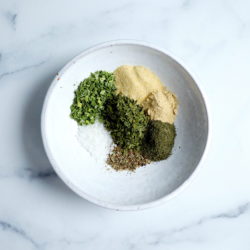 ingredients for dairy free ranch seasoning shown in a white bowl