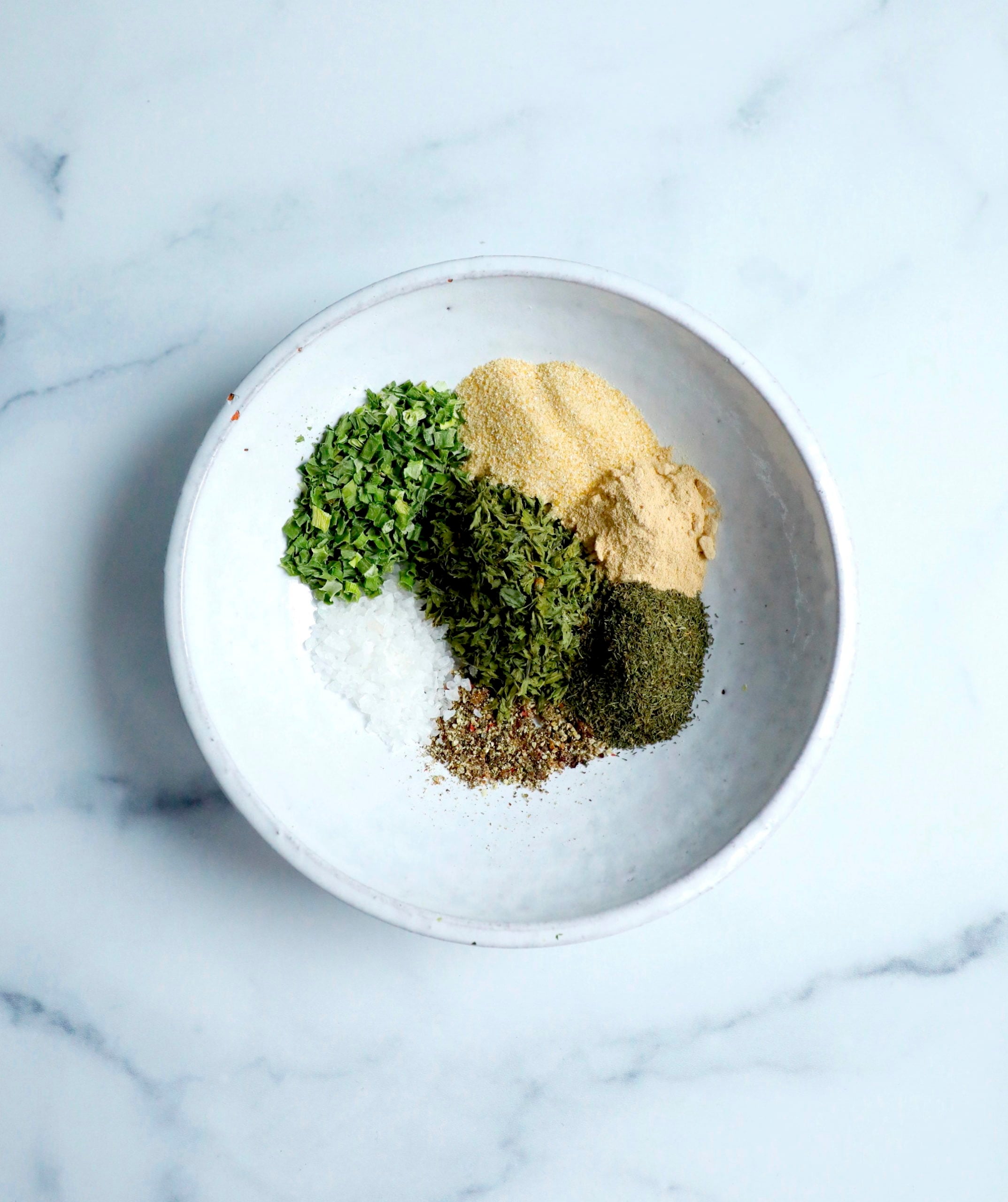 Dairy free ranch seasoning ingredients shown in a white bowl.