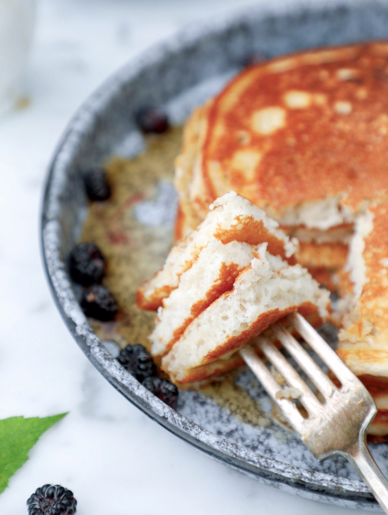 forkful of high protein pancakes showing the interior texture to be fluffy and light