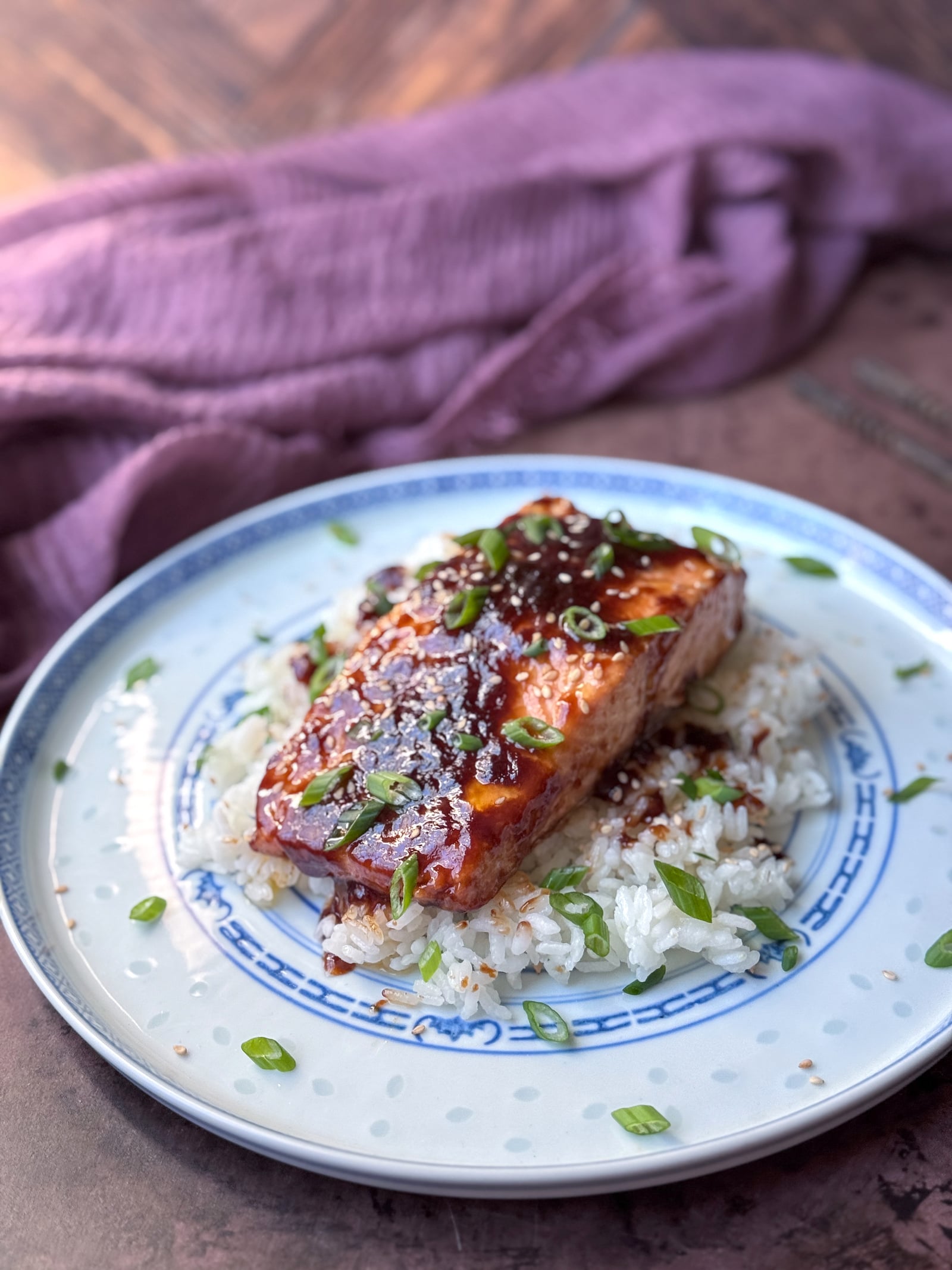 Roasted Salmon with hoisin butter on a bed of white rice with scallions and sesame seeds