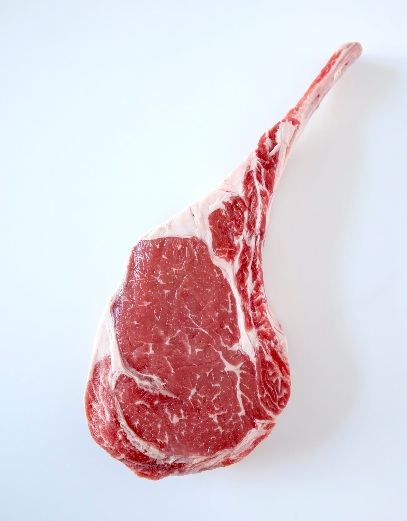 raw tomahawk steak on a white background
