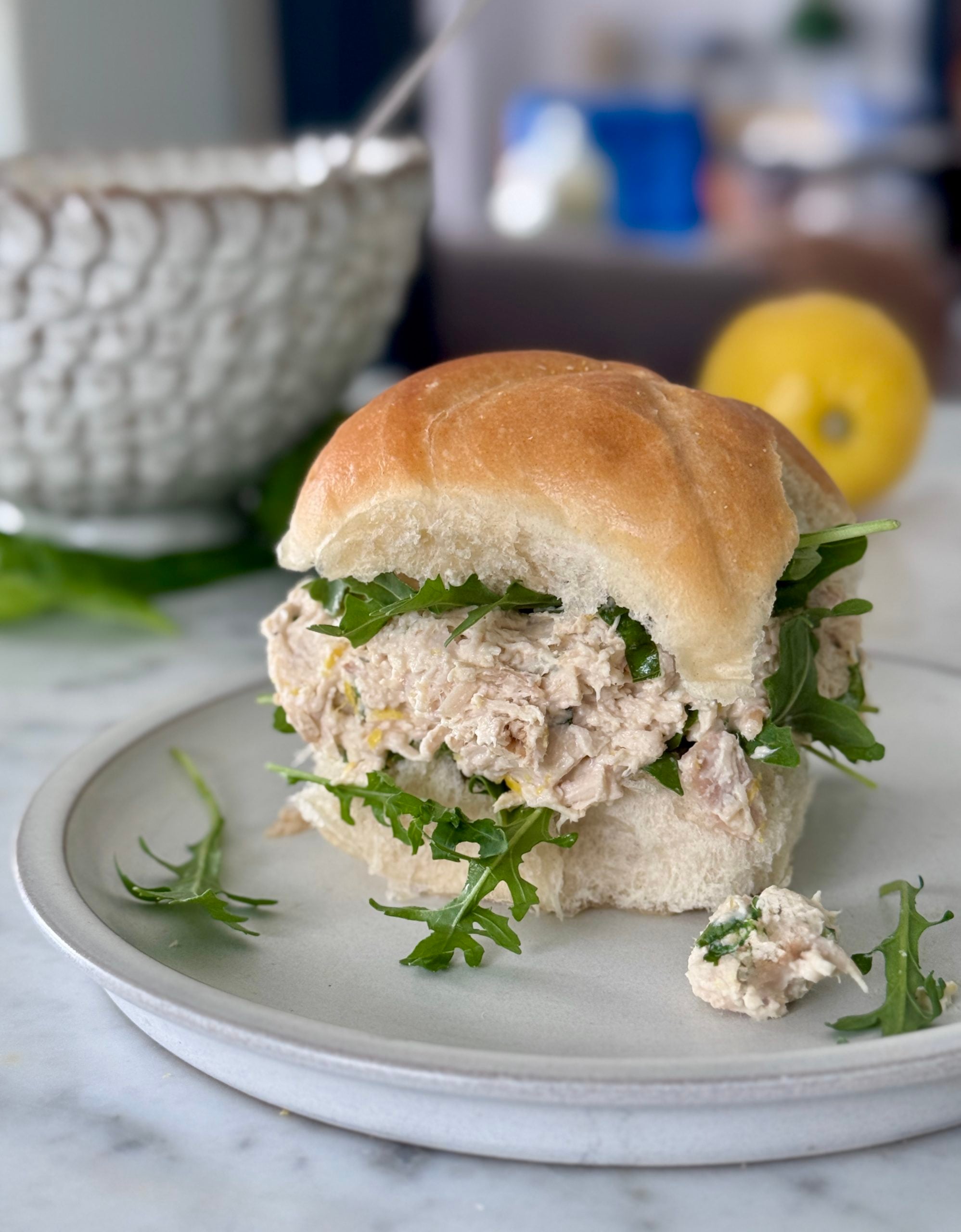 Chicken salad sandwich with arugula on a kaiser roll