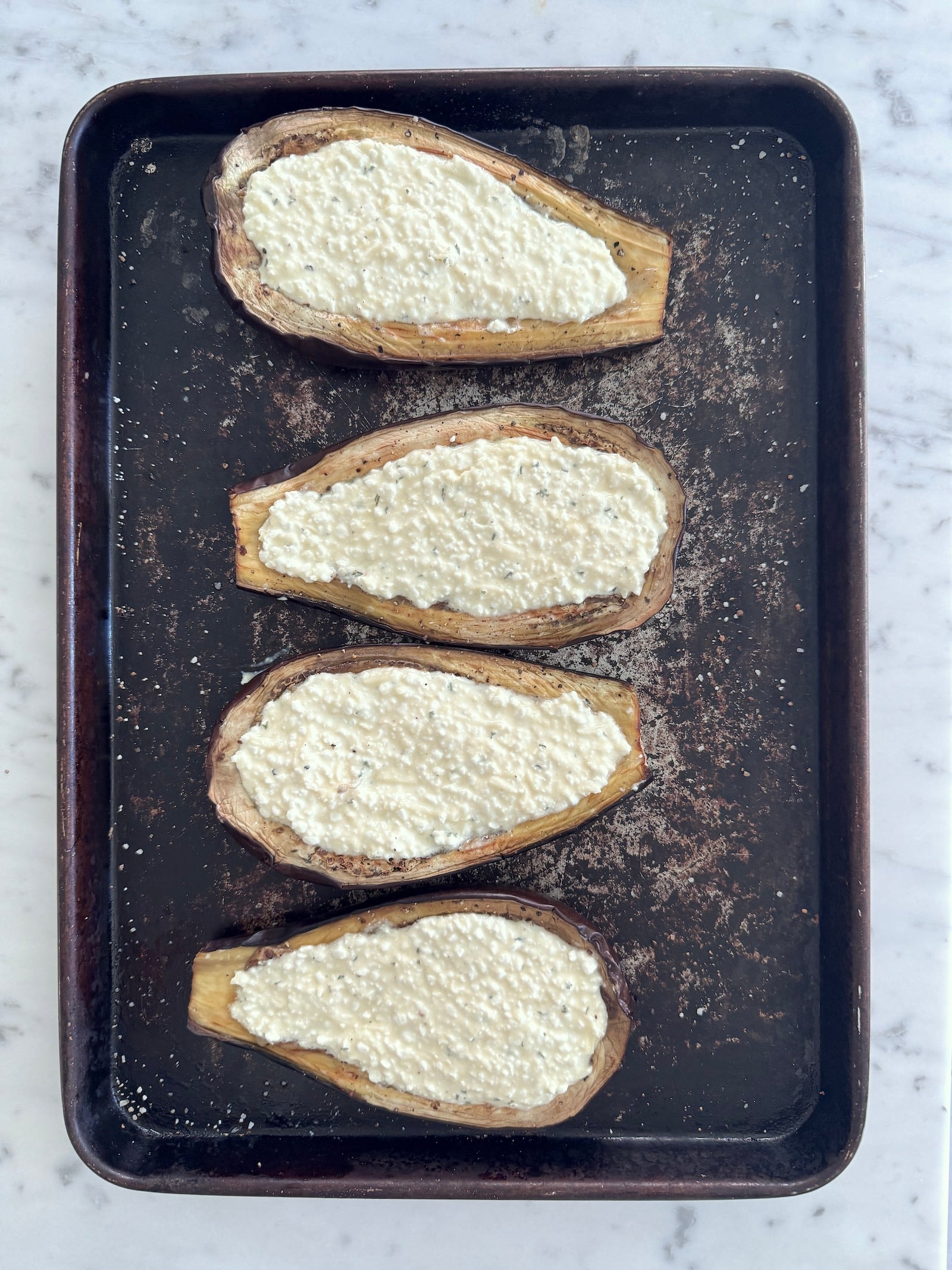 roasted eggplant halves full of high protein cottage cheese filling